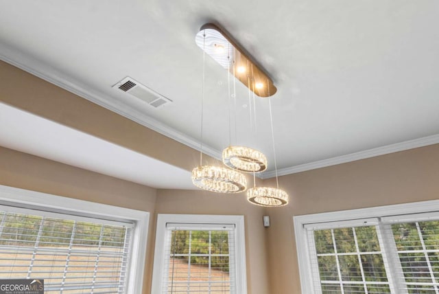 interior details featuring ornamental molding and an inviting chandelier