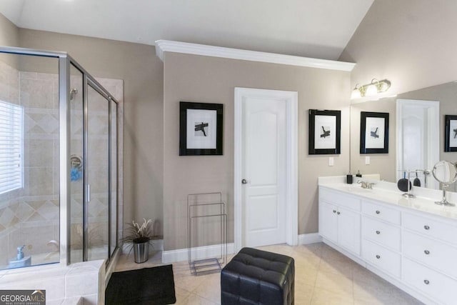 bathroom with a shower with door, vanity, vaulted ceiling, and tile patterned floors