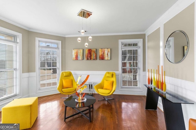 living area featuring dark wood-type flooring and ornamental molding