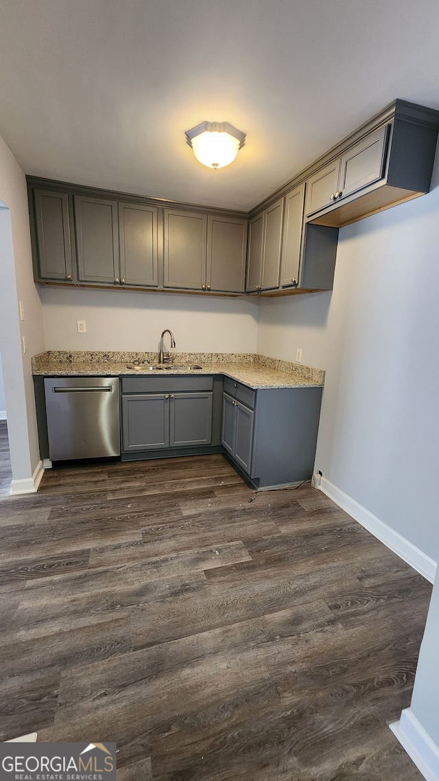 kitchen with gray cabinets, dishwasher, sink, and dark hardwood / wood-style floors