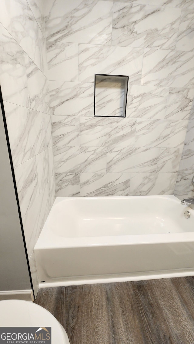 bathroom featuring wood-type flooring and toilet