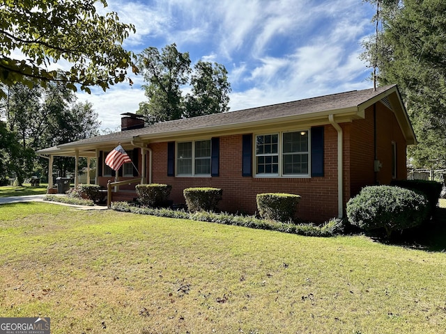 ranch-style home featuring a porch and a front yard