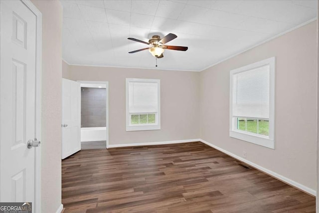 unfurnished room featuring crown molding, wood finished floors, baseboards, and ceiling fan