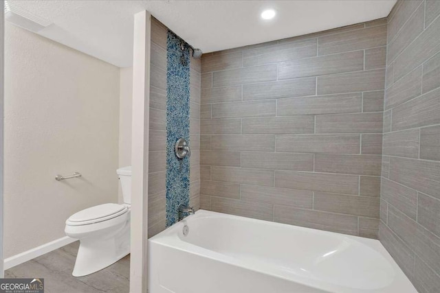bathroom with recessed lighting, toilet, baseboards, and shower / washtub combination