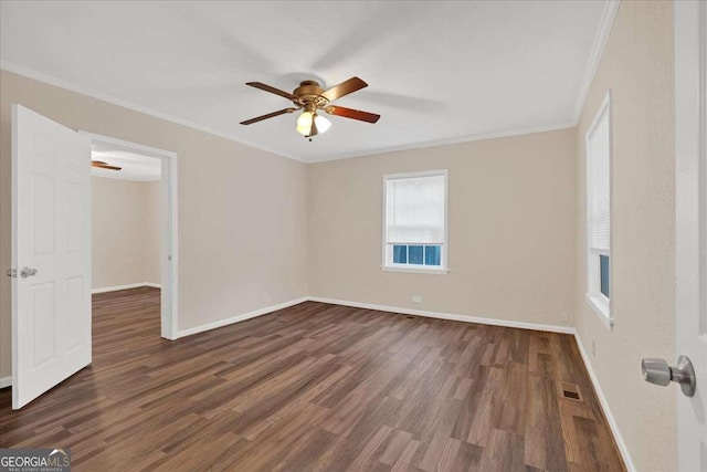 spare room featuring baseboards, visible vents, wood finished floors, and a ceiling fan