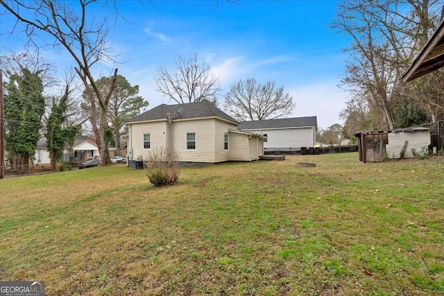 exterior space with a yard, an outbuilding, a storage shed, and crawl space