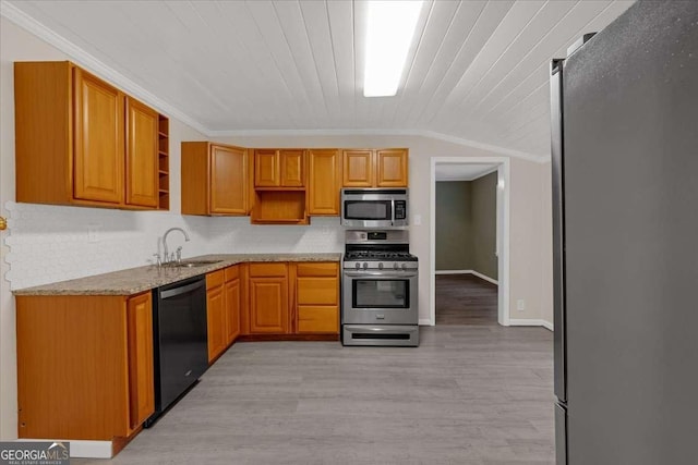 kitchen featuring light stone countertops, ornamental molding, a sink, open shelves, and stainless steel appliances