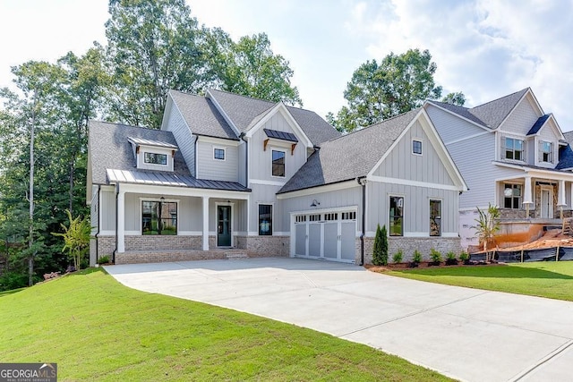 modern farmhouse style home featuring a garage, covered porch, and a front yard