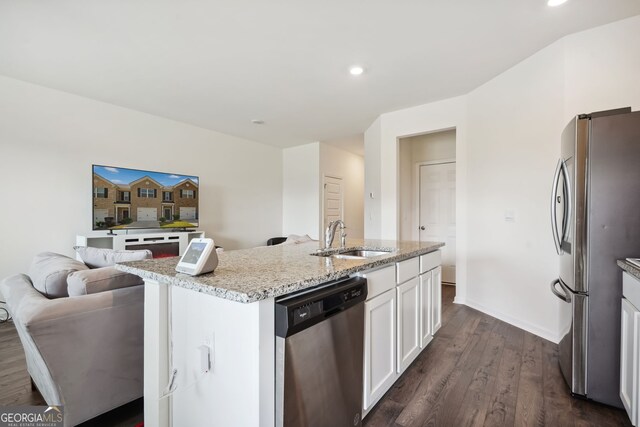 815 Taurus Dr, Stockbridge, GA 30281 - kitchen featuring sink, stainless steel appliances, light stone countertops, an island with sink, and white cabinets