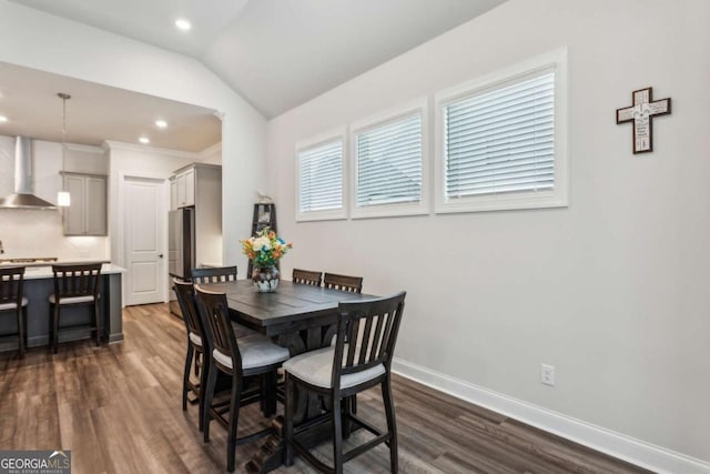 dining room with lofted ceiling and dark hardwood / wood-style flooring