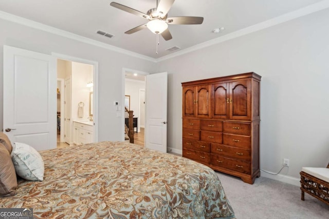 bedroom with crown molding, ensuite bath, light colored carpet, and ceiling fan