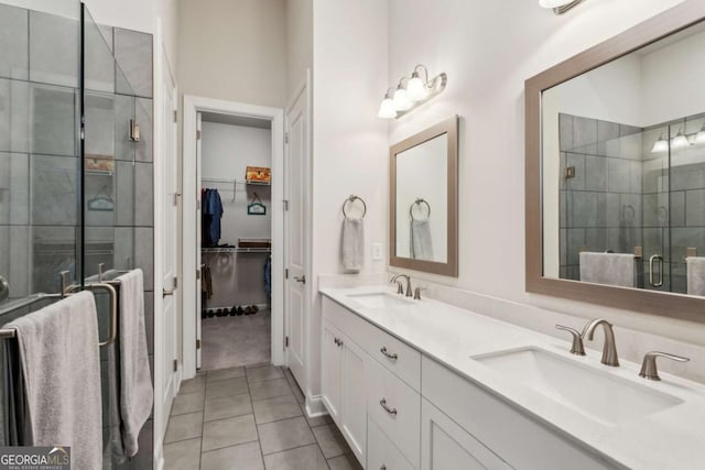 bathroom featuring vanity, an enclosed shower, and tile patterned flooring