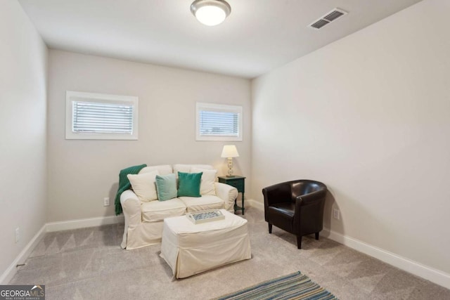 living area featuring light colored carpet