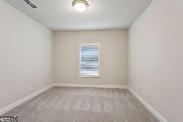 spare room with light carpet