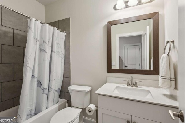 full bathroom with shower / bathtub combination with curtain, vanity, and toilet