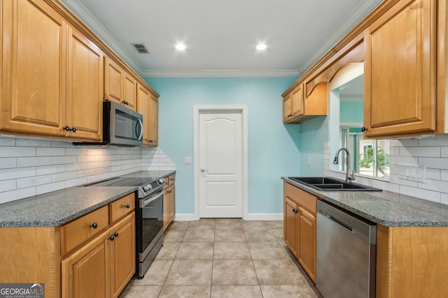 17 Coastal Walk, Saint Marys, GA 31558 - kitchen featuring sink, light tile patterned floors, ornamental molding, appliances with stainless steel finishes, and decorative backsplash