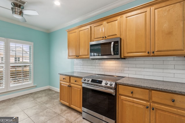 17 Coastal Walk, Saint Marys, GA 31558 - kitchen featuring light tile patterned floors, crown molding, appliances with stainless steel finishes, decorative backsplash, and dark stone counters