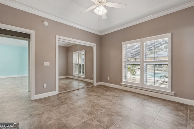 17 Coastal Walk, Saint Marys, GA 31558 - unfurnished bedroom with crown molding, ceiling fan, a closet, and light tile patterned floors