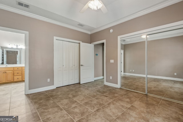 17 Coastal Walk, Saint Marys, GA 31558 - unfurnished bedroom featuring sink, crown molding, ensuite bath, tile patterned flooring, and multiple closets