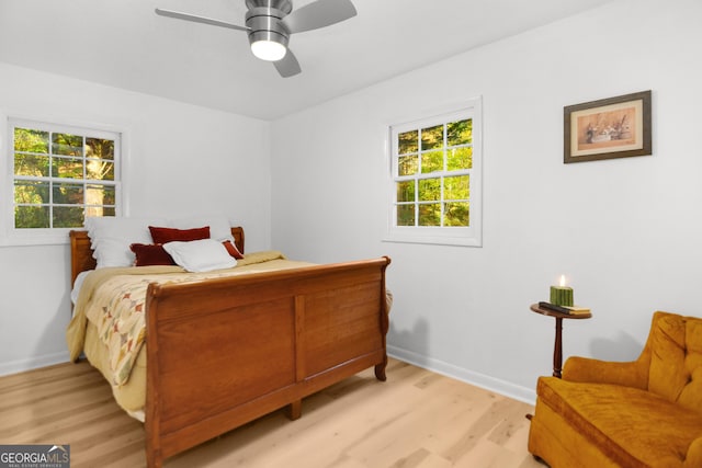 bedroom with ceiling fan and light hardwood / wood-style flooring