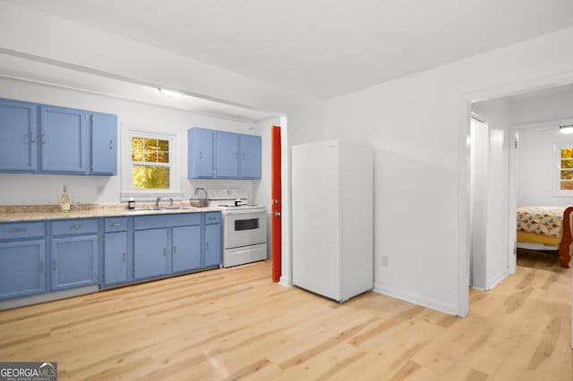 kitchen featuring blue cabinets, white electric stove, sink, and light hardwood / wood-style flooring