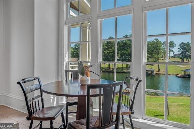 sunroom featuring a water view and a wealth of natural light