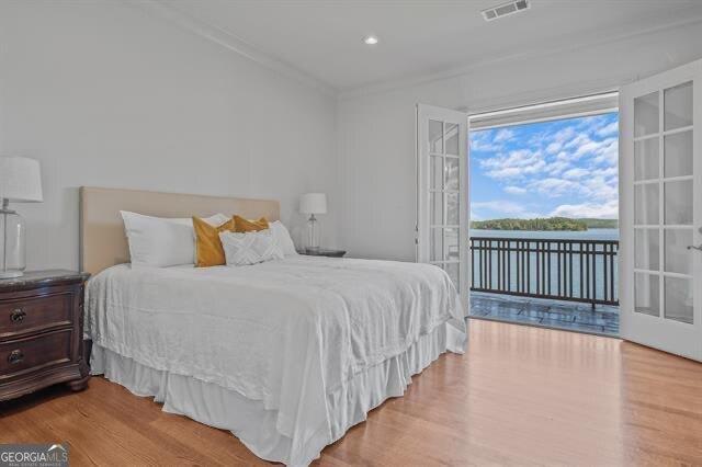 bedroom featuring ornamental molding, access to outside, and light wood-type flooring