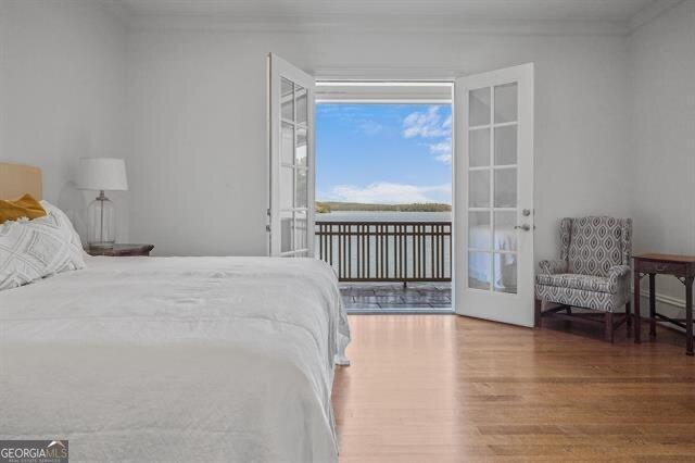 bedroom featuring wood-type flooring and access to exterior