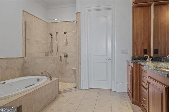 bathroom featuring vanity, tile patterned floors, and shower with separate bathtub