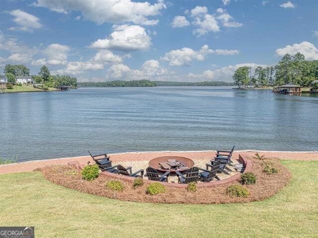 property view of water featuring an outdoor fire pit