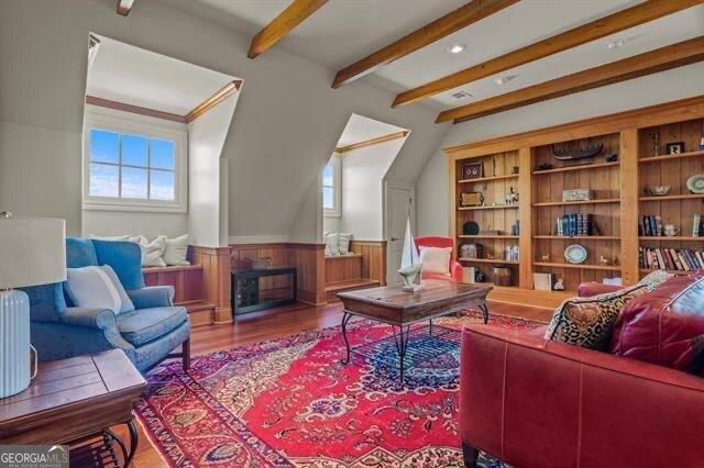 living room featuring beamed ceiling and hardwood / wood-style flooring