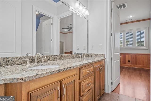 bathroom featuring vanity, tile patterned floors, and ornamental molding