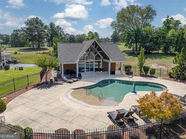 view of pool featuring a fireplace and a patio area