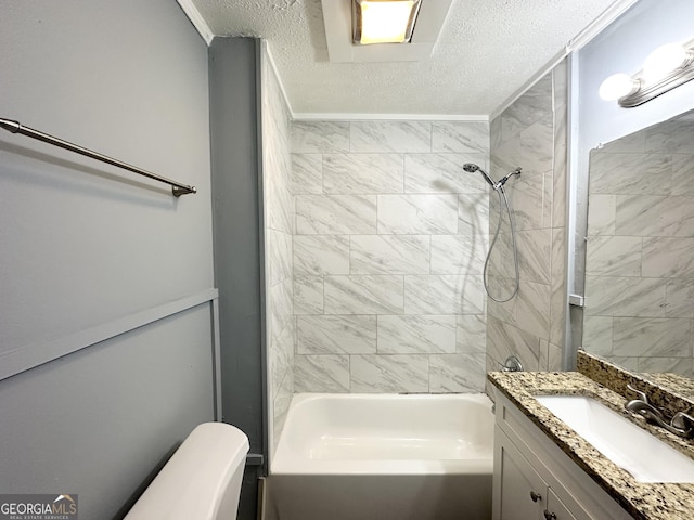 full bathroom with vanity, tiled shower / bath combo, toilet, and a textured ceiling