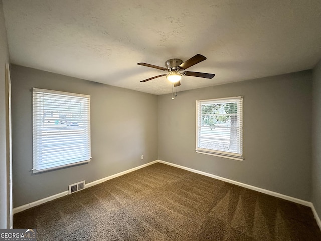 spare room featuring carpet flooring, a textured ceiling, and ceiling fan