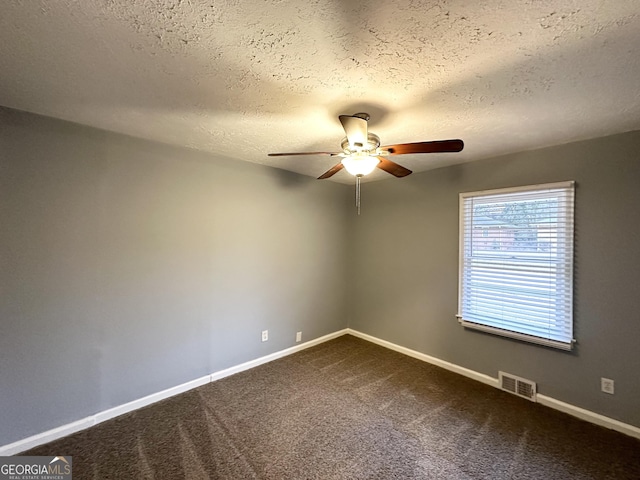 empty room with a textured ceiling, carpet floors, and ceiling fan