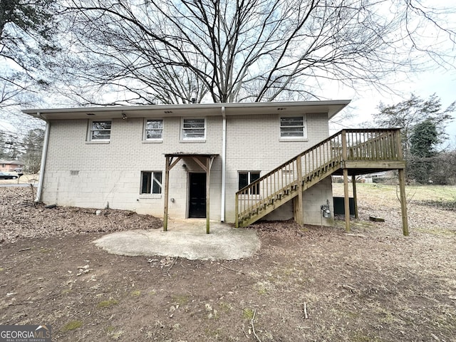 2004 Shamrock Dr, Decatur, GA 30032 - back of property with stairway, brick siding, a wooden deck, and a patio