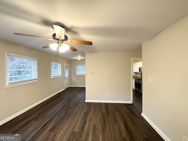 unfurnished room featuring dark wood-type flooring and ceiling fan