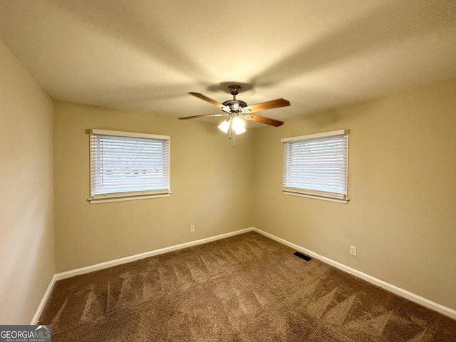 carpeted spare room with plenty of natural light and ceiling fan