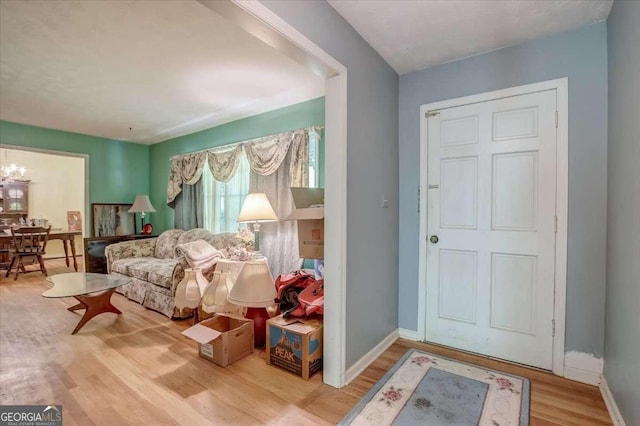 living area with hardwood / wood-style flooring and a chandelier