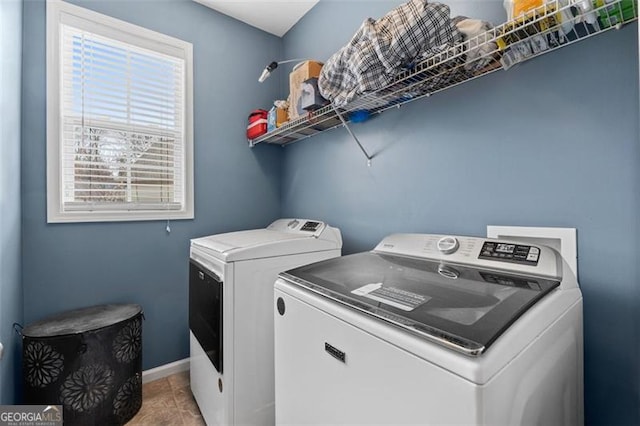 laundry area featuring tile patterned floors and washing machine and dryer