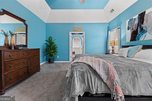 carpeted bedroom with ensuite bathroom and lofted ceiling