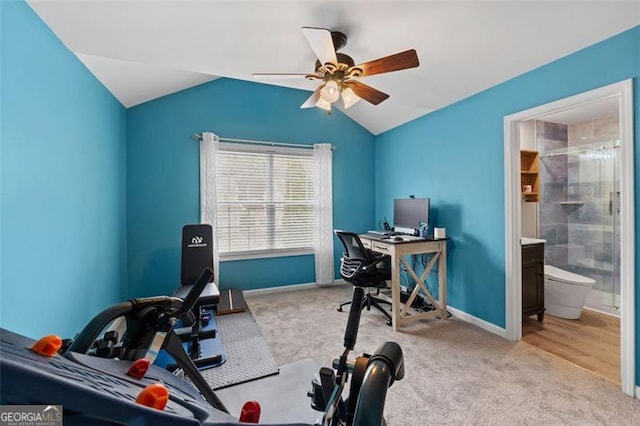 carpeted office featuring lofted ceiling and ceiling fan