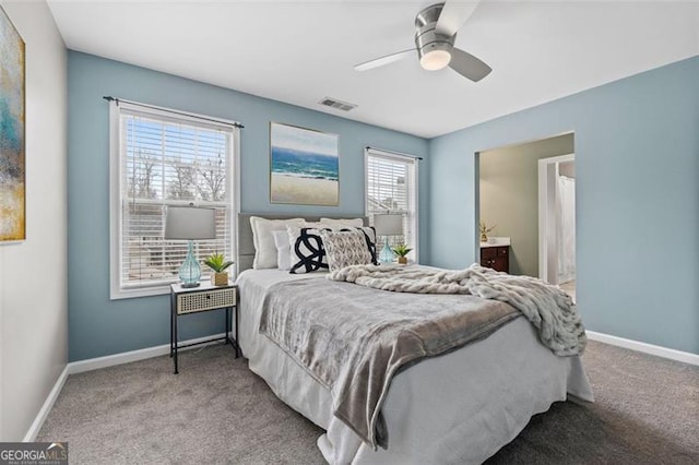 bedroom featuring light carpet, connected bathroom, and ceiling fan