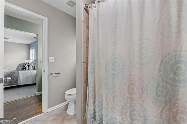 bathroom with tile patterned floors and toilet