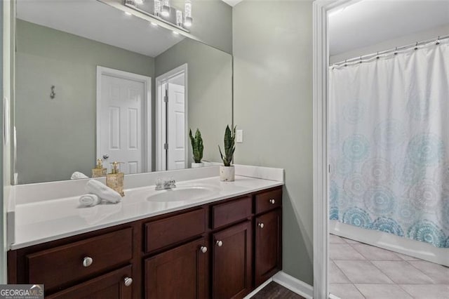 bathroom featuring vanity, tile patterned flooring, and shower / bath combo with shower curtain