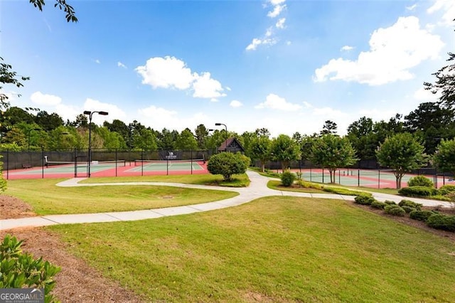 view of home's community with a yard and tennis court