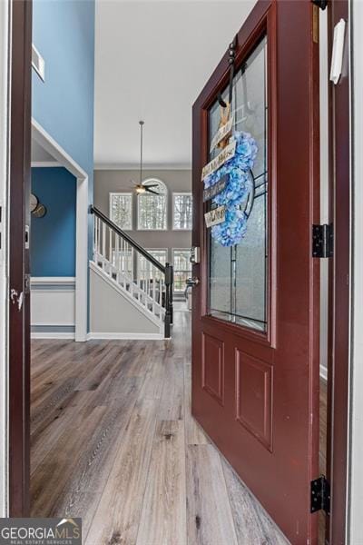 foyer with crown molding and hardwood / wood-style floors