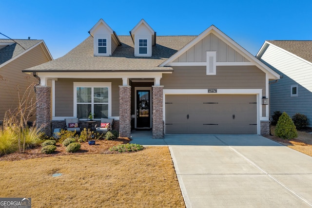 craftsman inspired home featuring a garage and covered porch