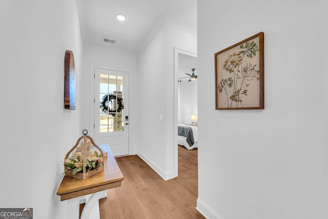 corridor with light hardwood / wood-style floors